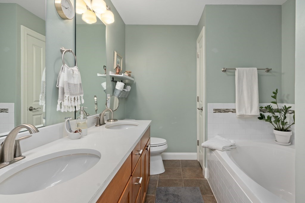 4 Mentas Circle Woburn, MA 01801 - Photo 21 of 41 a bathroom with a tub sink toilet and mirror