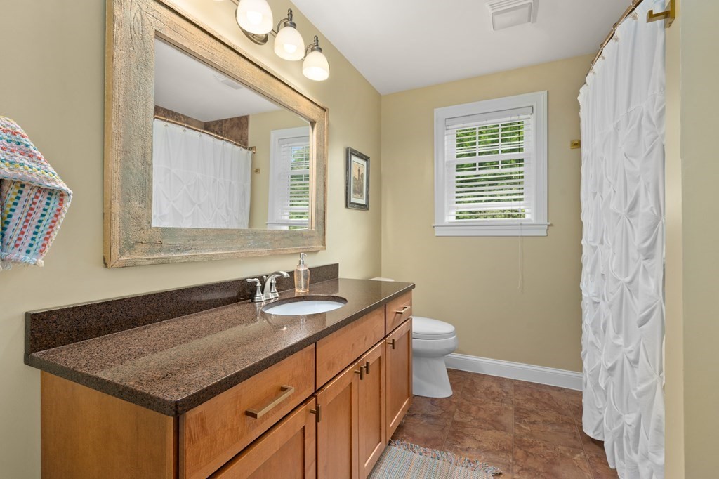 4 Mentas Circle Woburn, MA 01801 - Photo 24 of 41 a bathroom with a granite countertop sink a toilet and a mirror