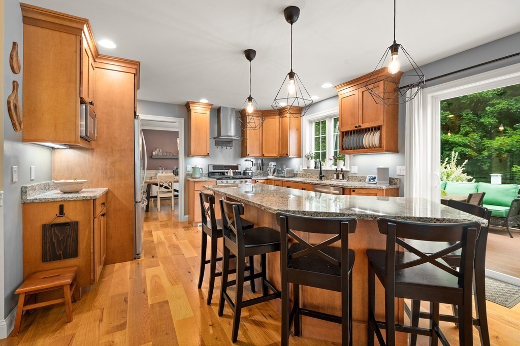 4 Mentas Circle Woburn, MA 01801 - Photo 3 of 41 a dining room with stainless steel appliances a dining table chairs and couches