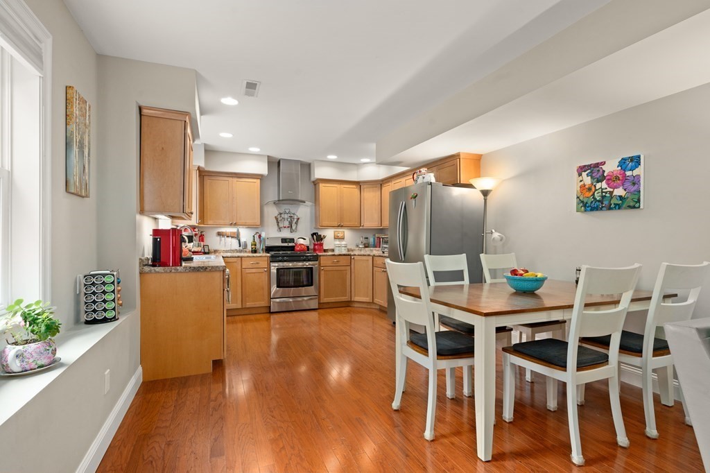 4 Mentas Circle Woburn, MA 01801 - Photo 31 of 41 a kitchen with kitchen island wooden floor cabinets and stainless steel appliances