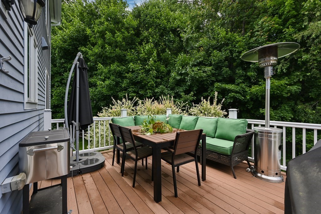 4 Mentas Circle Woburn, MA 01801 - Photo 35 of 41 a patio with wooden floor a yard a table and chairs