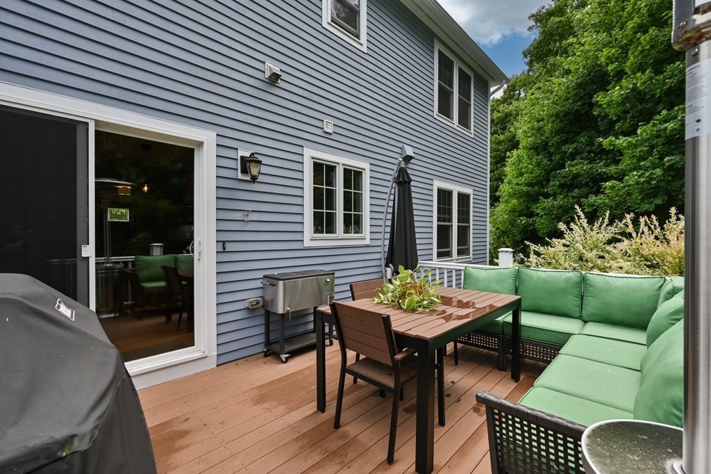 4 Mentas Circle Woburn, MA 01801 - Photo 36 of 41 a backyard of a house with dining table and chairs with plants