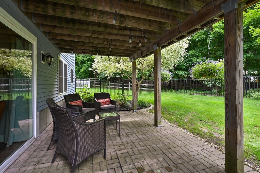 4 Mentas Circle Woburn, MA 01801 - Photo 37 of 41 a view of a patio with a table chairs and a backyard