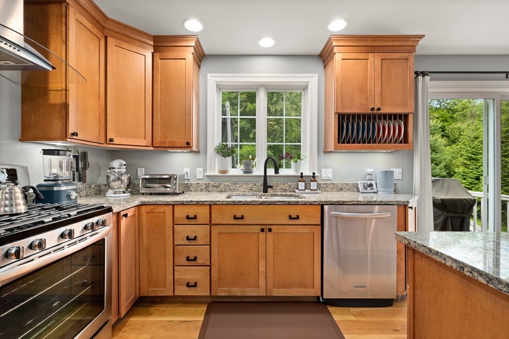 4 Mentas Circle Woburn, MA 01801 - Photo 5 of 41 a kitchen with stainless steel appliances granite countertop a stove a sink and a microwave
