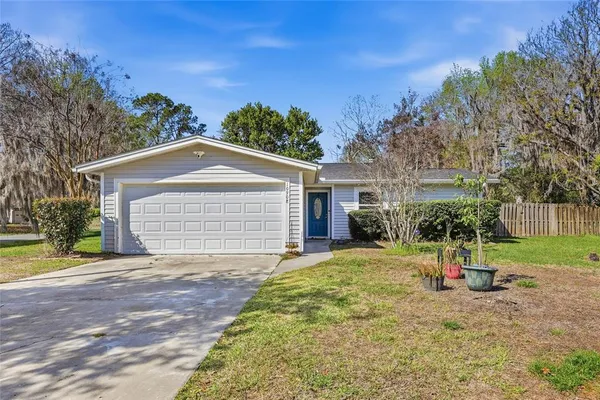 a view of a house with a yard and garage