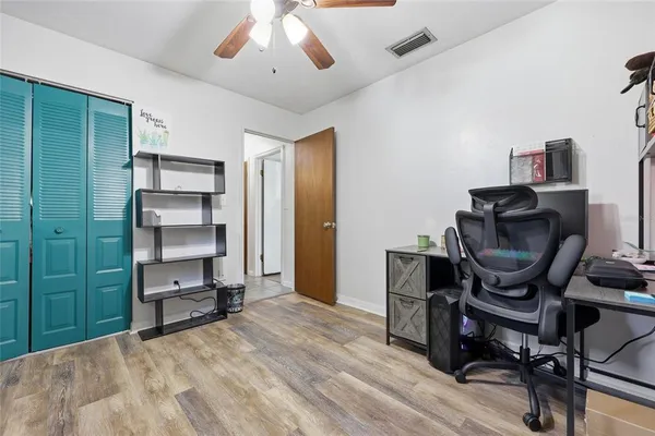 a view of a workspace with furniture and a window