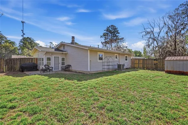 a view of a house with a backyard