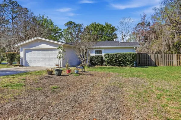 a view of a house with yard and sitting area