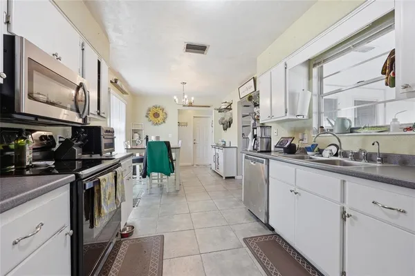 a kitchen with stainless steel appliances granite countertop a sink and cabinets