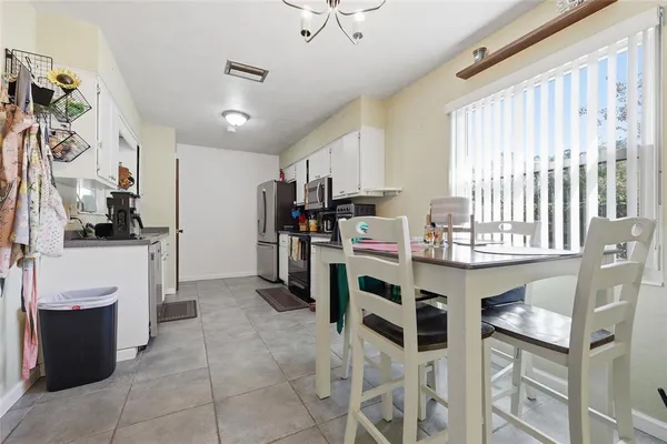 a kitchen with stainless steel appliances kitchen island granite countertop a refrigerator and microwave