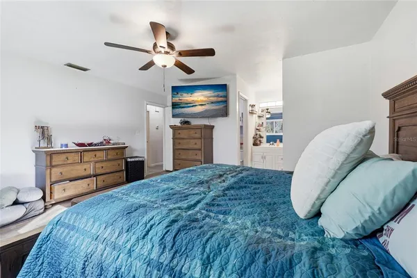 a bedroom with a bed and a dresser