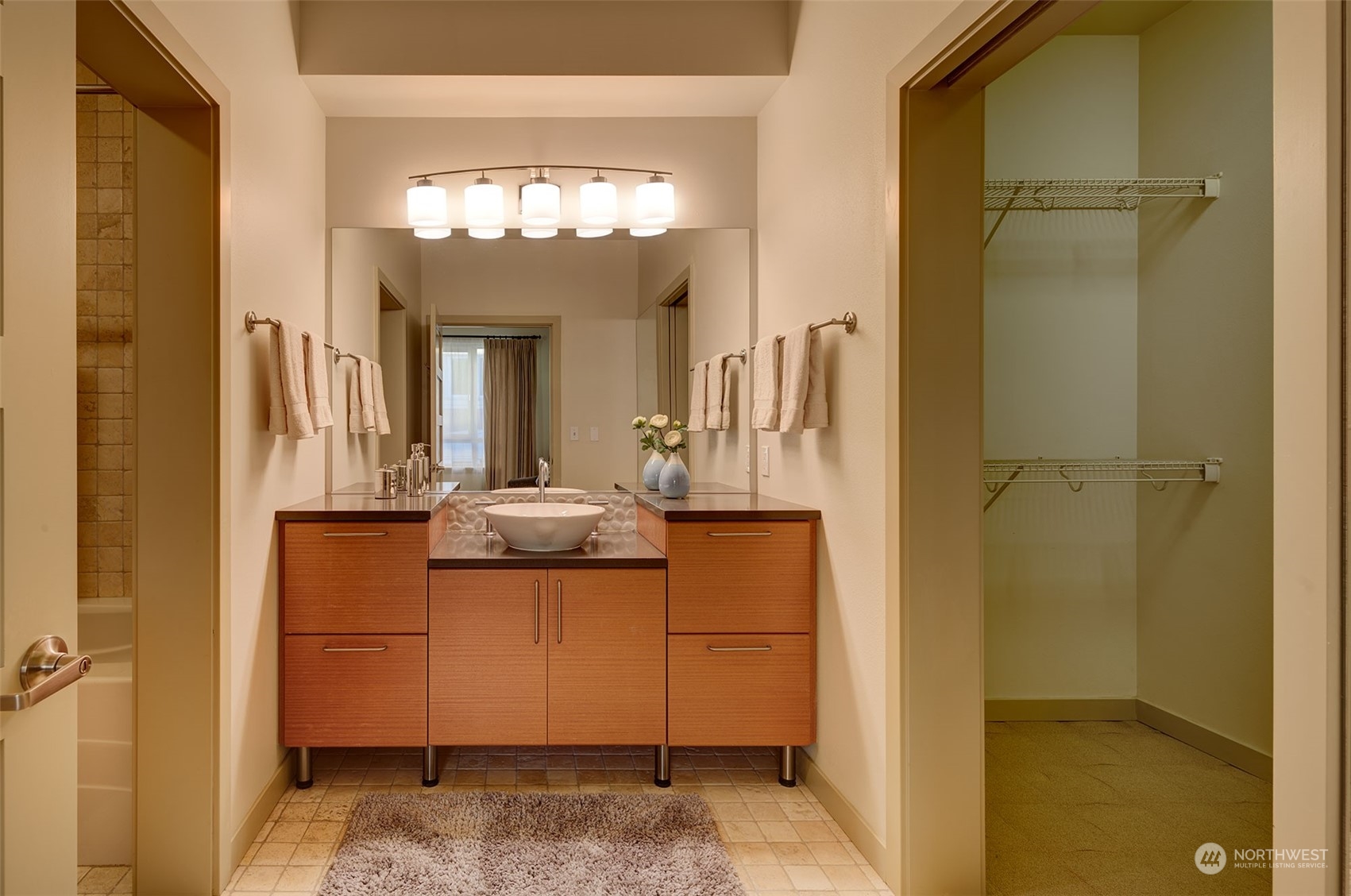 1530 Northwest Market Street, Unit 812 Seattle, WA 98107 - Photo 14 of 34 a bathroom with a granite countertop sink and a mirror
