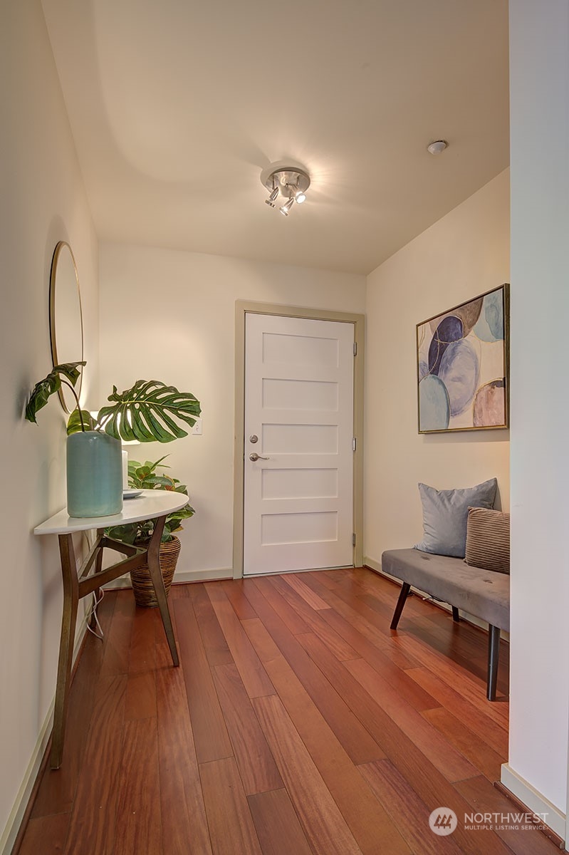 1530 Northwest Market Street, Unit 812 Seattle, WA 98107 - Photo 5 of 34 a living room with furniture and a wooden floor