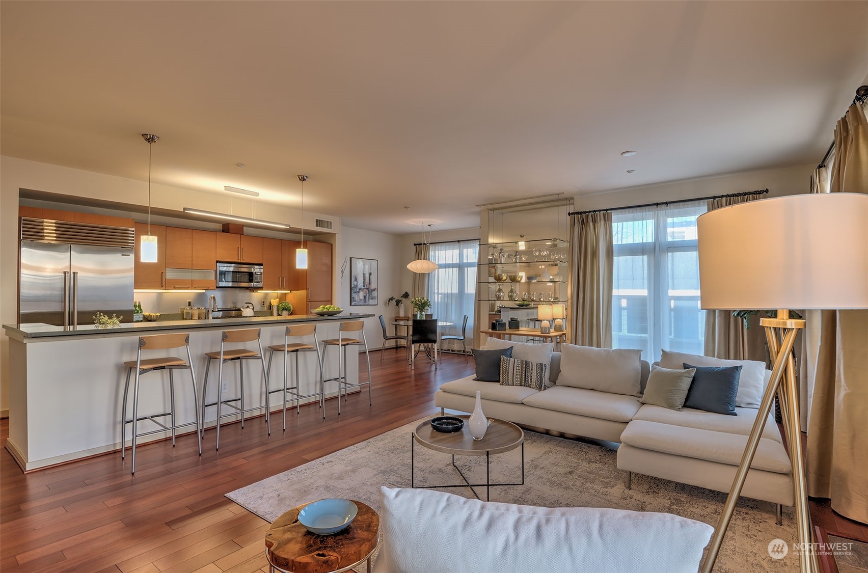 1530 Northwest Market Street, Unit 812 Seattle, WA 98107 - Photo 6 of 34 a living room with kitchen island furniture and a wooden floor