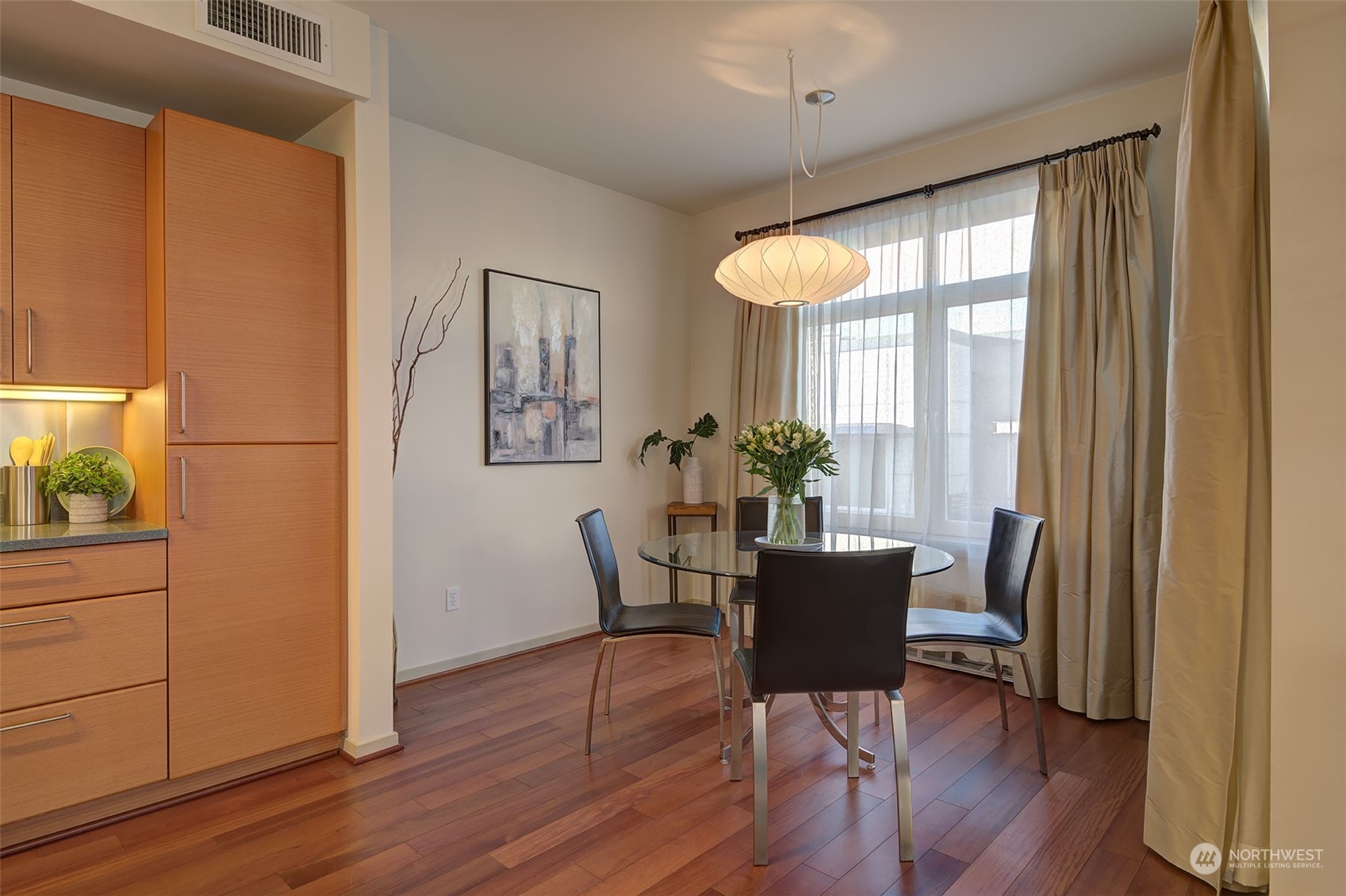1530 Northwest Market Street, Unit 812 Seattle, WA 98107 - Photo 9 of 34 a dining room with furniture window and wooden floor