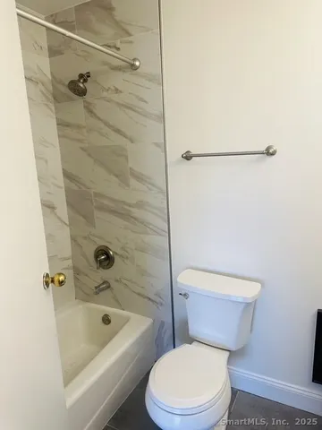 a white toilet and shower
