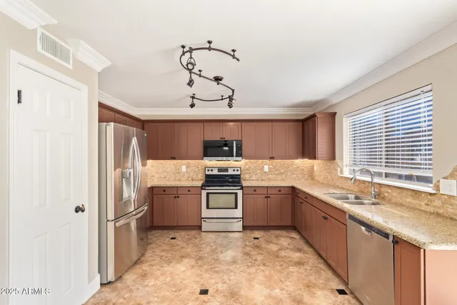 a large kitchen with a stove and a refrigerator