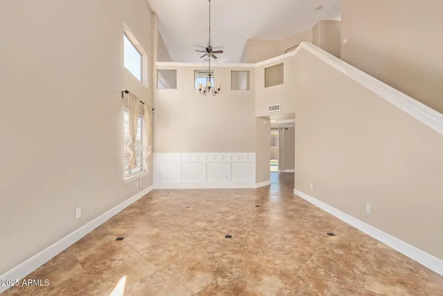 a view of a big room with windows and chandelier