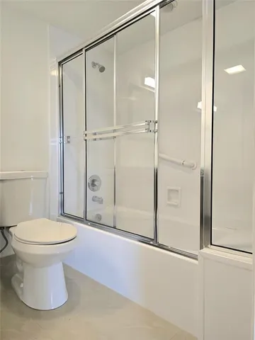 a bathroom with a toilet and a shower