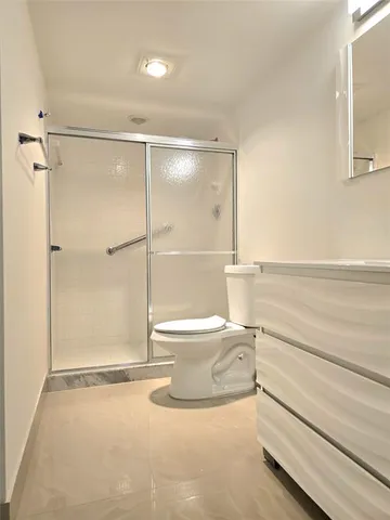 a bathroom with a toilet and a shower