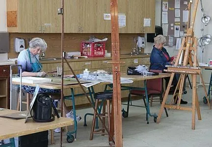 a room with view of a kitchen counter and chairs
