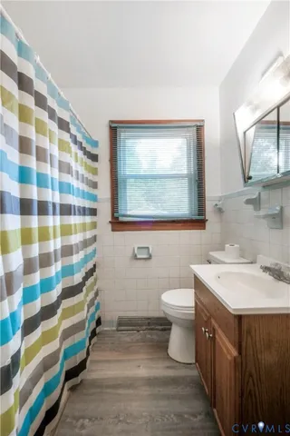 a bathroom with a sink toilet and mirror