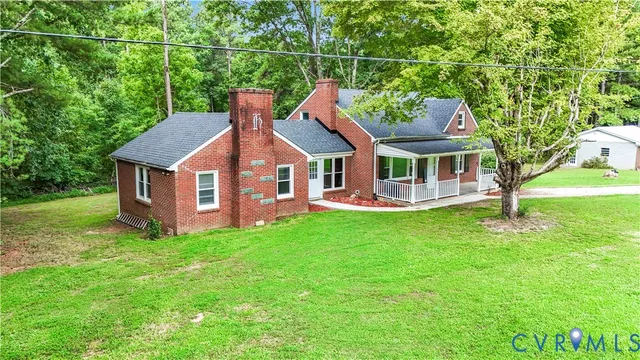 a aerial view of a house with a yard table and chairs