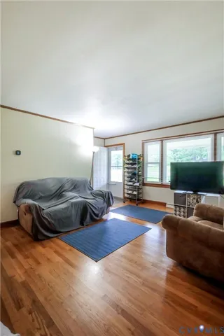 a bedroom with furniture and a wooden floor