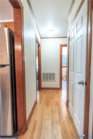a view of hallway with wooden floor