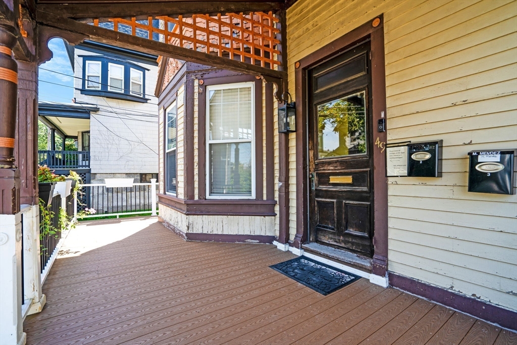 49 Elmore Street, Unit 3 Boston, MA 02119 - Photo 2 of 12 a view of a house with a barbeque