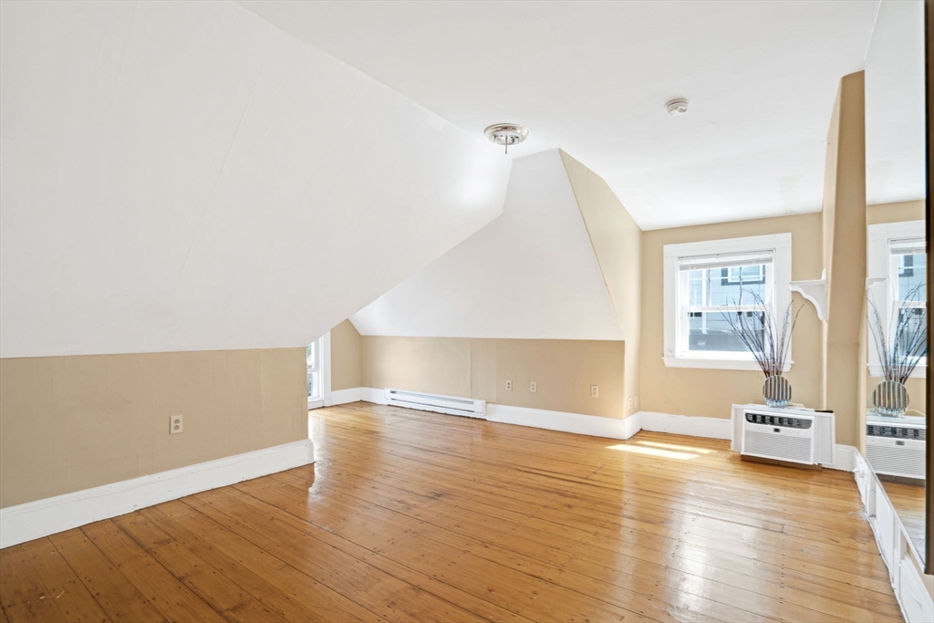 49 Elmore Street, Unit 3 Boston, MA 02119 - Photo 3 of 12 a view of empty room with wooden floor