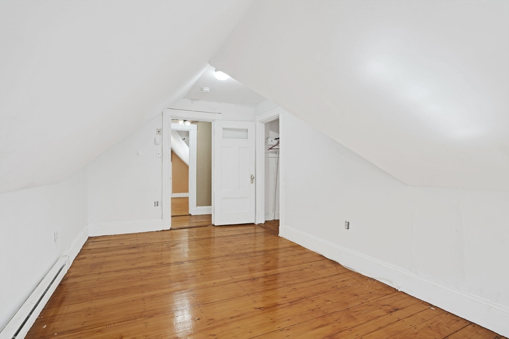 49 Elmore Street, Unit 3 Boston, MA 02119 - Photo 4 of 12 a view of an empty room with wooden floor and closet