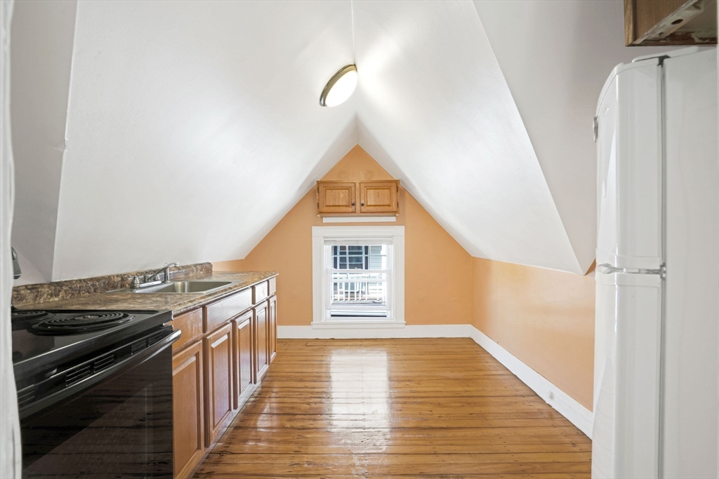 49 Elmore Street, Unit 3 Boston, MA 02119 - Photo 8 of 12 a view of a hallway with wooden floor and staircase
