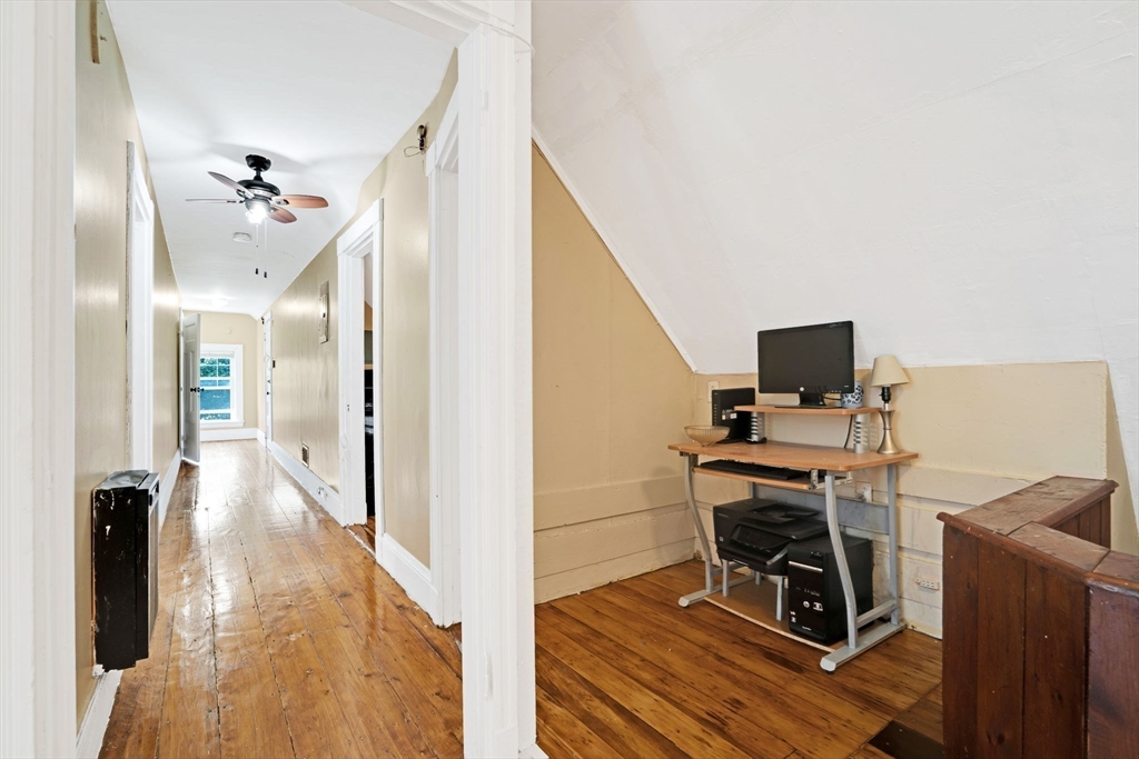 49 Elmore Street, Unit 3 Boston, MA 02119 - Photo 9 of 12 a view of a workspace with furniture and gym equipment