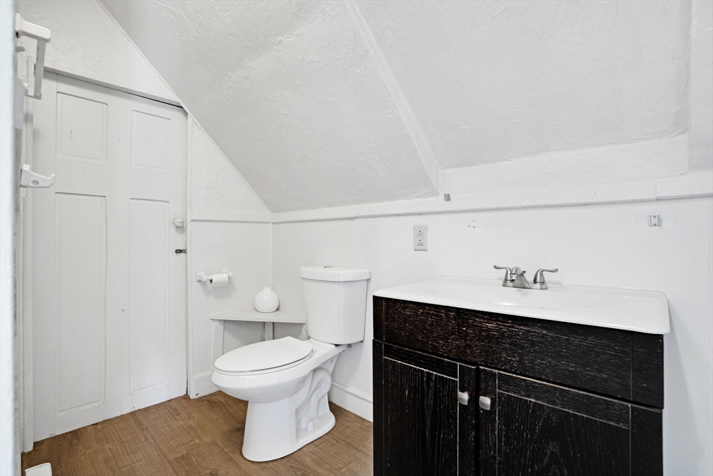 49 Elmore Street, Unit 3 Boston, MA 02119 - Photo 10 of 12 a bathroom with a sink a toilet and a mirror