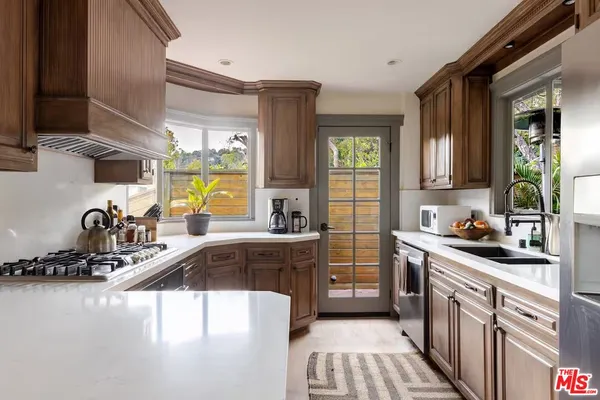 a kitchen with a sink stove and cabinets