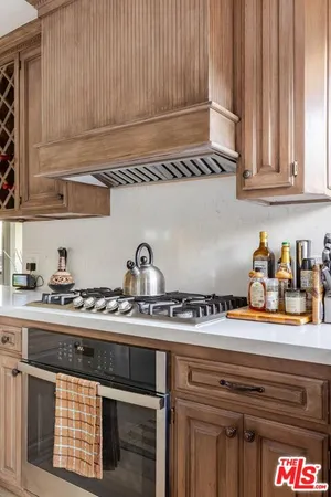 a kitchen with stainless steel appliances granite countertop a sink and cabinets