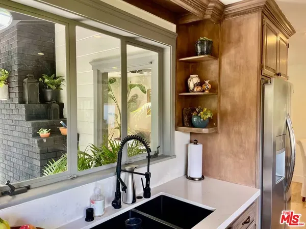 a kitchen with stainless steel appliances a sink a stove and a window