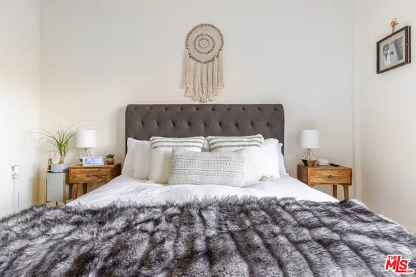 a bedroom with a bed and a mirror