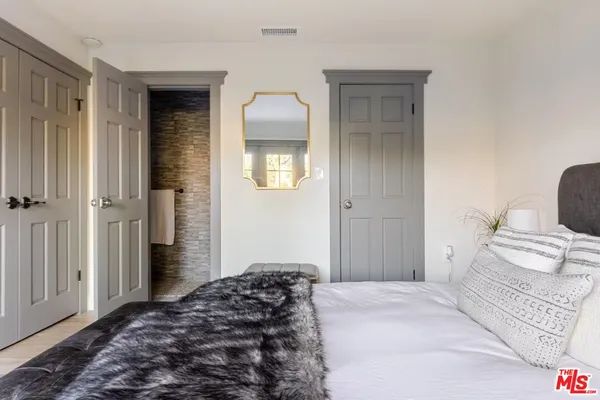 a bedroom with a bed and a view of balcony