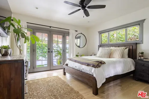 a bedroom with a bed a flat screen tv and a couch