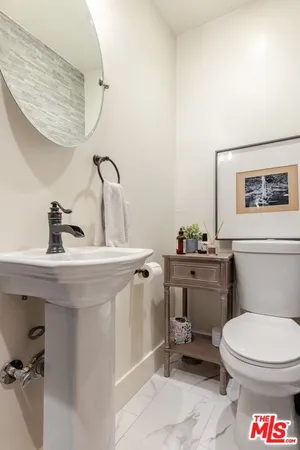 a bathroom with a sink a mirror and a shower