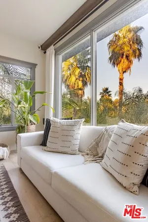 a living room with couch and a large window