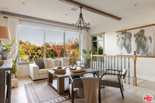 a living room with furniture and a chandelier