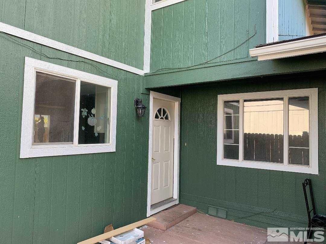 10042 Humite Lane Reno, NV 89506 - Photo 1 of 3 a front view of a house with a green gate