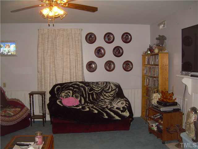 1424 Sykes Road Spring Hope, NC 27882 - Photo 3 of 9 a bedroom with a bed and a chair