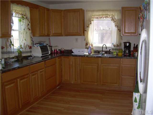 1424 Sykes Road Spring Hope, NC 27882 - Photo 5 of 9 a kitchen with sink cabinets and window