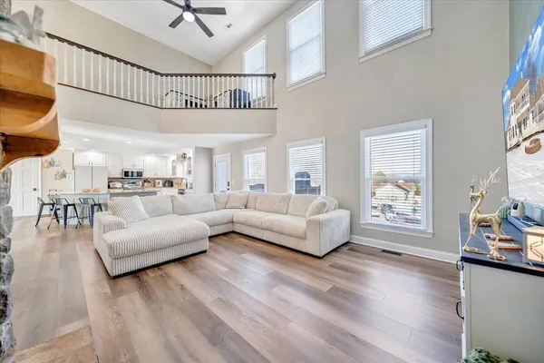 a work room with wooden floor and ceiling fan