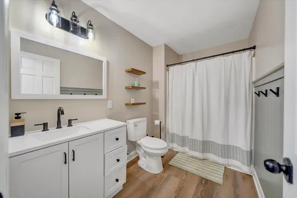 a view of a white house with a snow in the yard