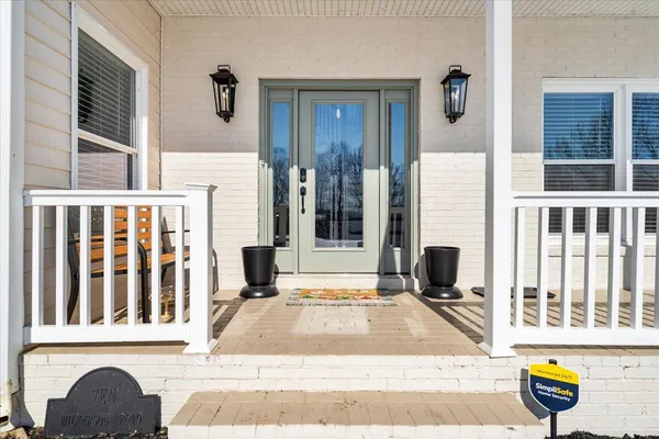 a kitchen with stainless steel appliances granite countertop a stove top oven a sink dishwasher and a refrigerator with wooden floor